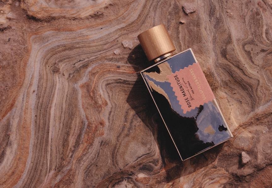 Goldfield & Banks Rose Magnitude perfume bottle placed on textured natural stone surface with earthy tones, showcasing luxury niche fragrance packaging and Australian-inspired design