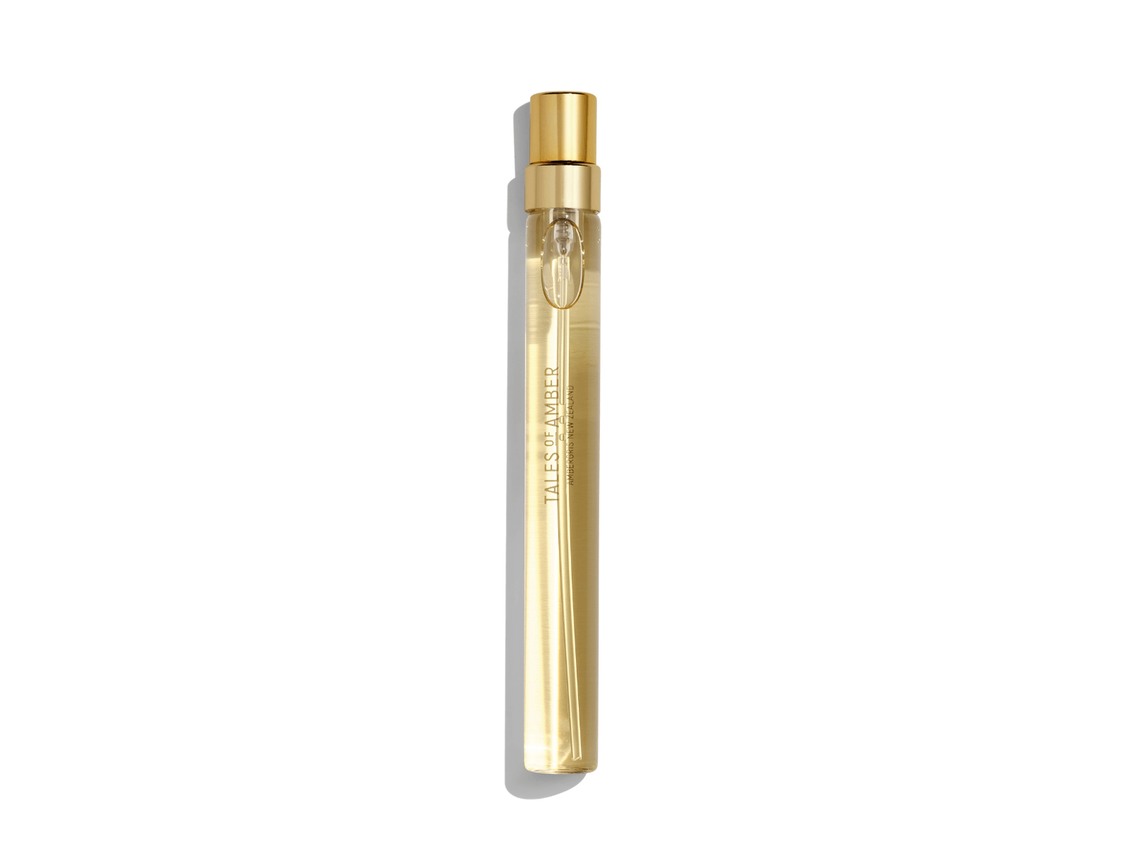 Tales of Amber gold spray perfume bottle on white background