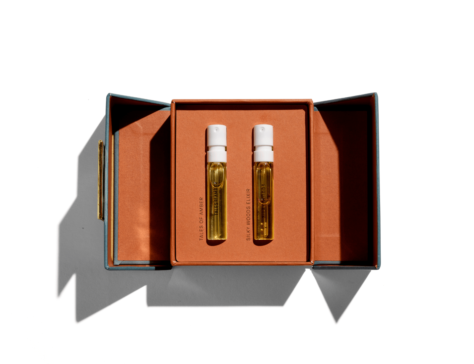Discovery Set with Tales of Amber and Silky Woods Elixir Duo in an open orange box